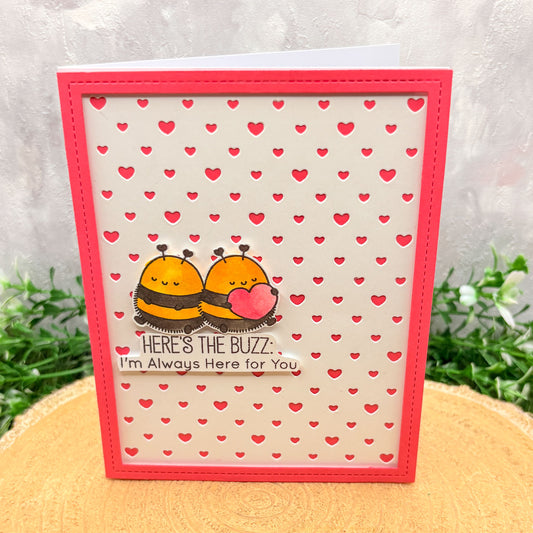 Card with two bees holding a heart and text 'Here's the Buzz. I'm Always Here for You' on a heart-patterned background.