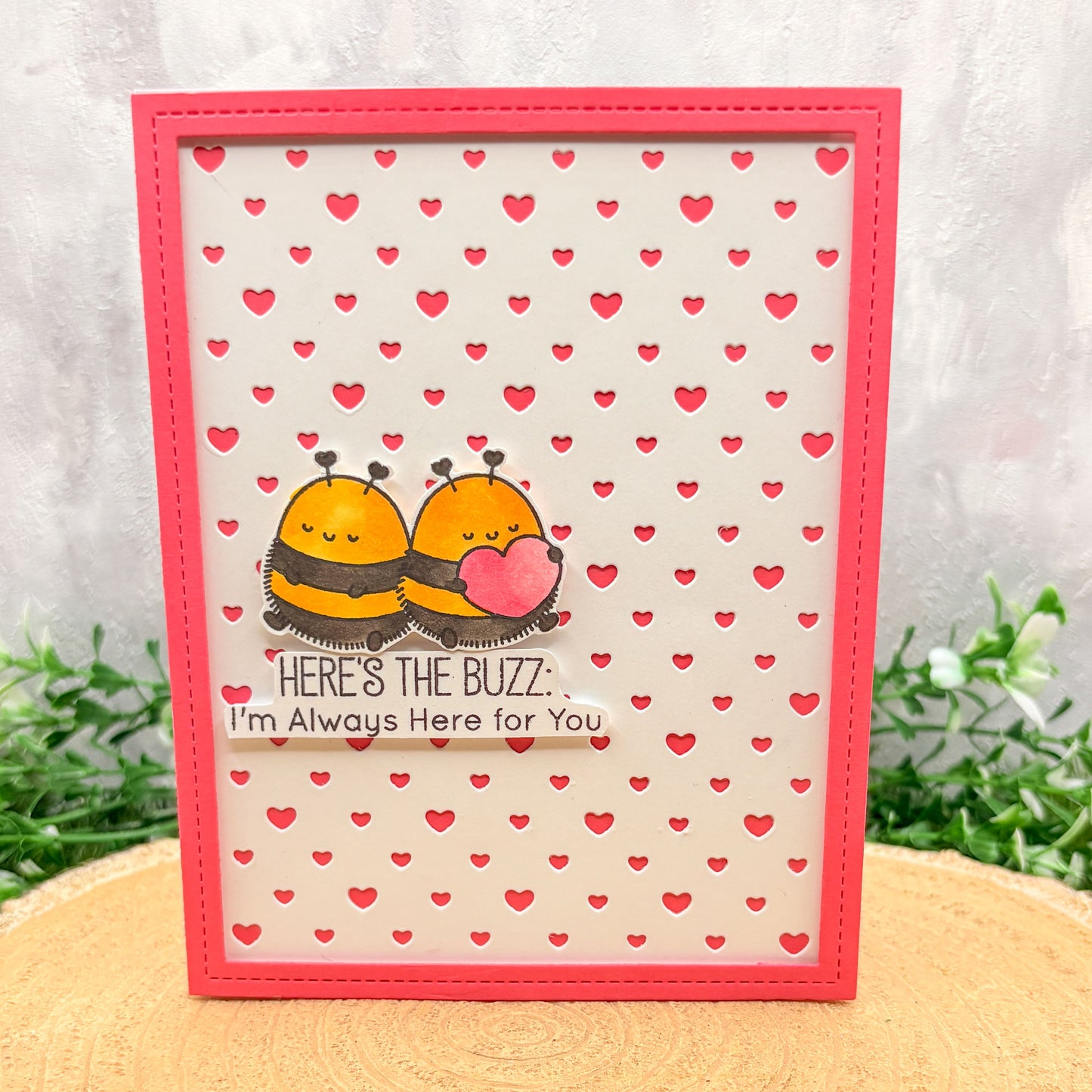 Greeting card with cartoon bees and heart pattern on a white background