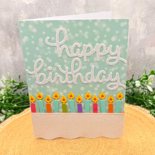 Birthday card with colorful candles on a light green background
