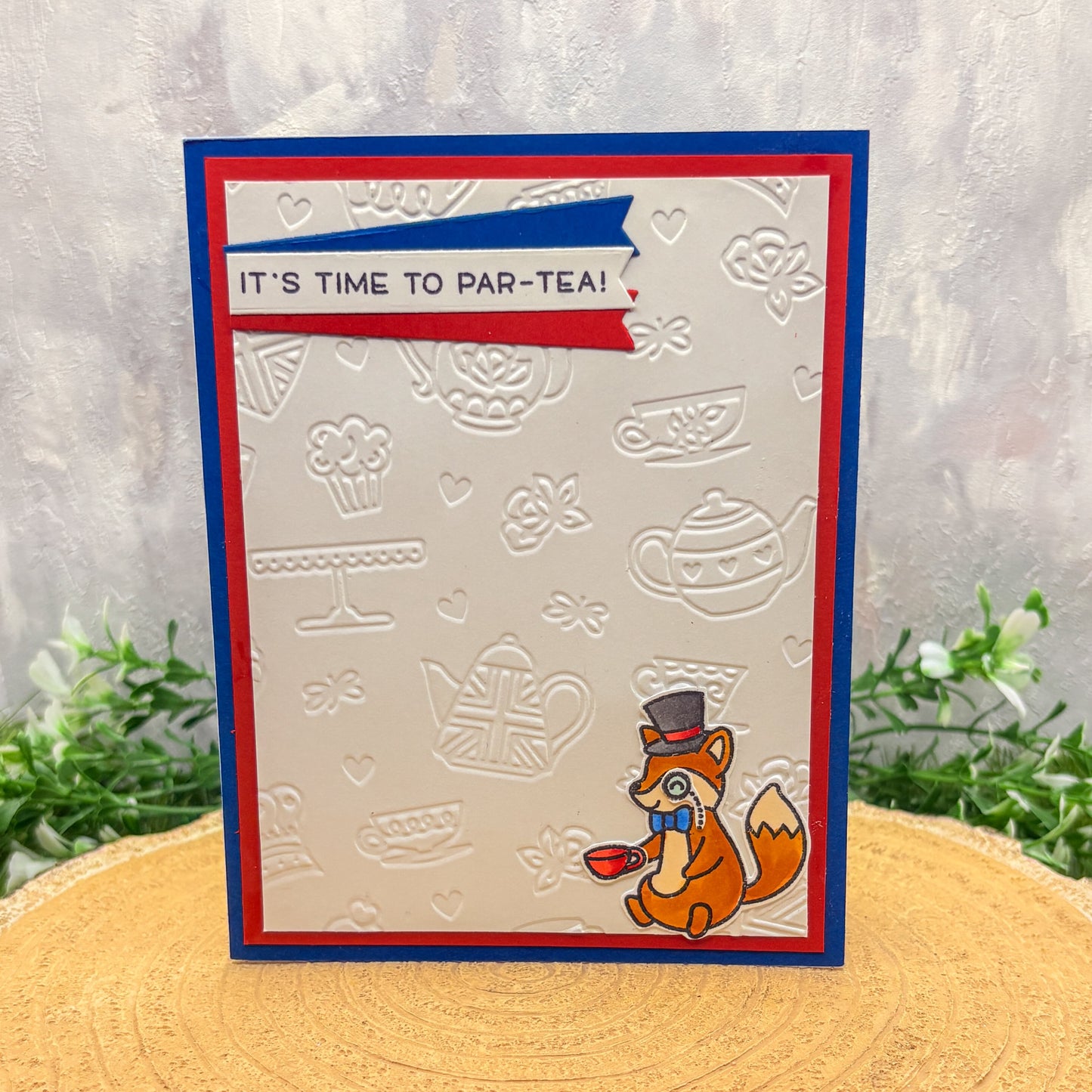 Card with a fox design and 'It's time to par-tea!' text on a textured background.