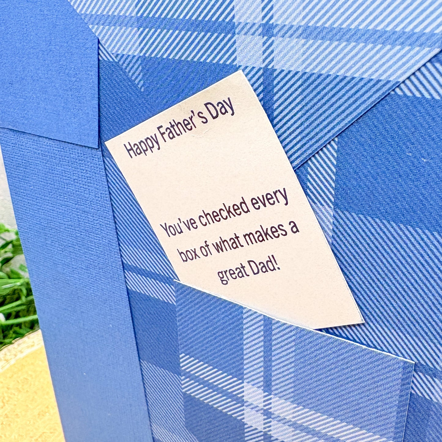 Blue plaid Father's Day card with a message on a blue background